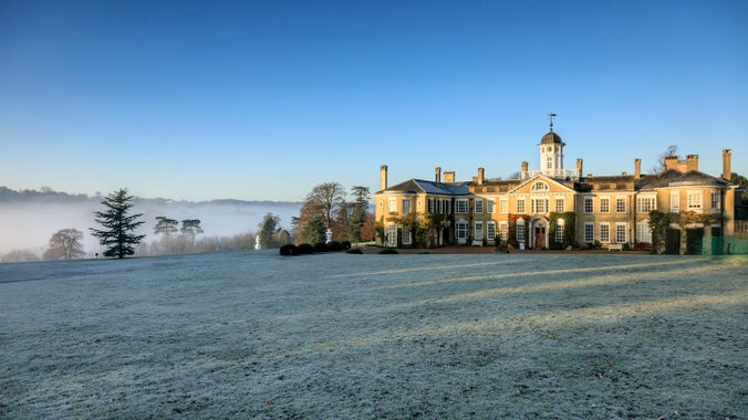 View of the house at Polesden Lacey in winter and frosty lawns